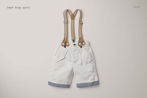 Boys formal set mockup showing white shorts with tan suspenders and blue striped trim, displayed flat on light surface.