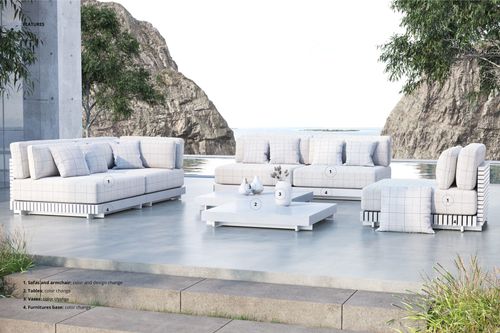 PSD mockup scene featuring modular garden sofas, white cushions, and a square coffee table on a concrete terrace outdoors.