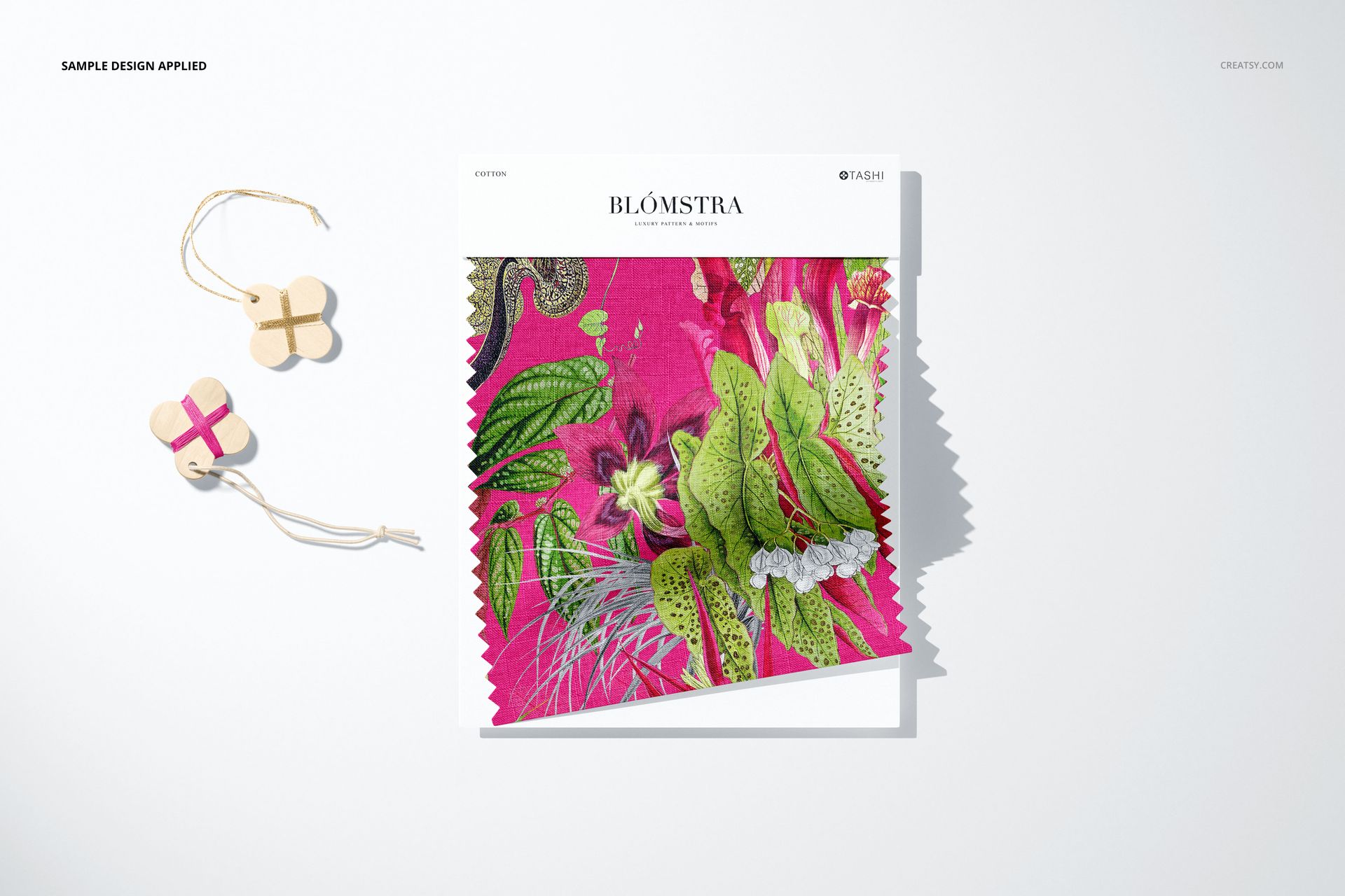 Fabric swatch mockup featuring a vibrant pink and green botanical pattern, displayed from a top view on a white background.