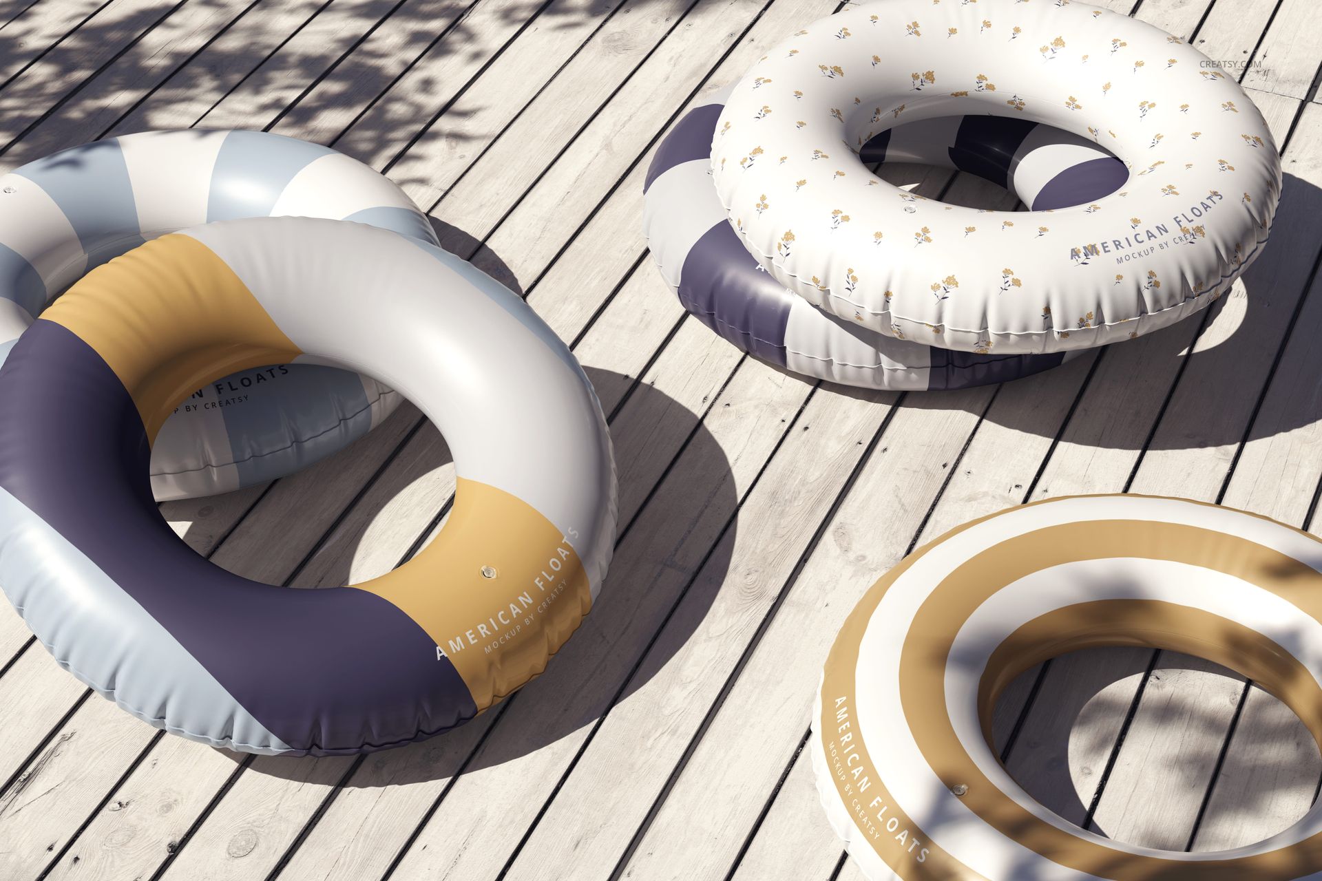 PSD mockup of round swim rings in assorted blue, beige, and white designs, placed outdoors on wooden planks.