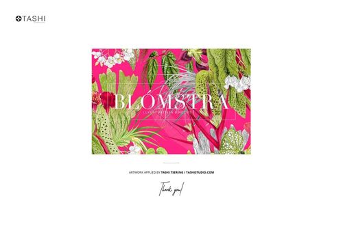 Fabric mockup displayed on a mossy rock, featuring a vibrant pink background with green and white botanical patterns.