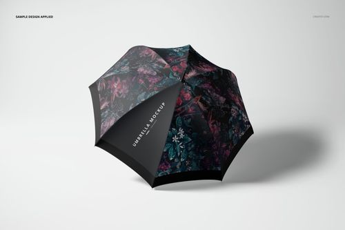 Open umbrella with dark floral pattern, viewed from above at an angle on a light background, fashion accessory mockup.