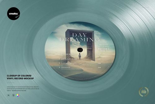 Detailed close-up of a teal vinyl record mockup, featuring a surreal desert scene on the central label area.