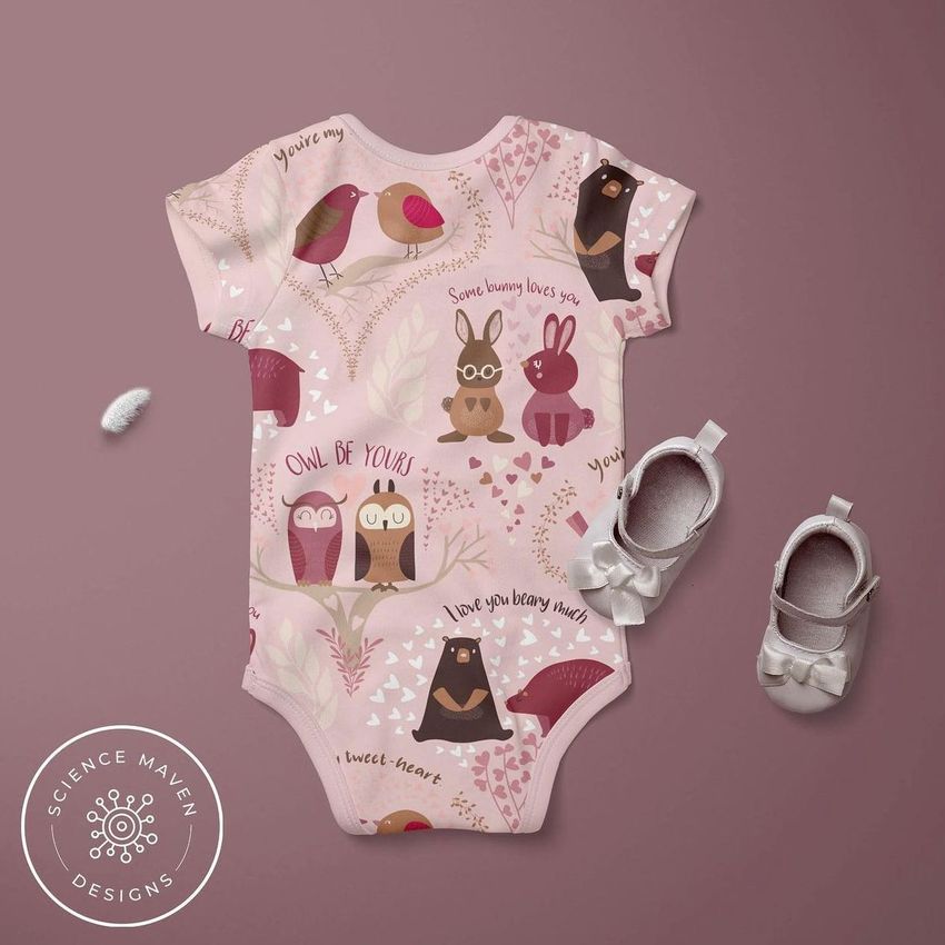 Baby short sleeve bodysuit mockup displayed on a mauve background with illustrated animals and text, paired with baby shoes.