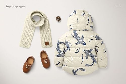 Kids winter set mockup featuring a cream puffer jacket with blue fish pattern, scarf, shoes, and pinecone on white background.