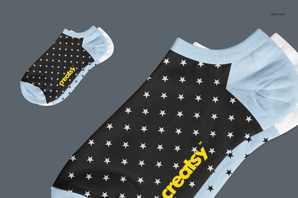 PSD mockup of adult low cut socks featuring a black and white star design with light blue heel and toe details.