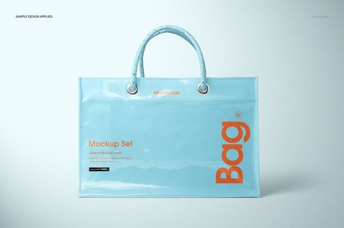 Vinyl PVC tote bag mockup in light blue with glossy finish, orange lettering, and sturdy handles, shown from the front.