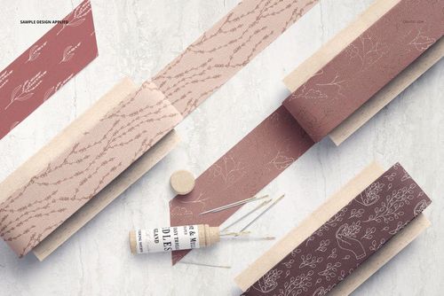 Cotton ribbon mockup featuring several ribbons with subtle plant designs, displayed on wooden paddles from above.