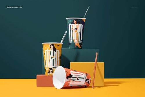 PSD mockup showing three patterned paper cups with straws, arranged on colored blocks, viewed from the front.