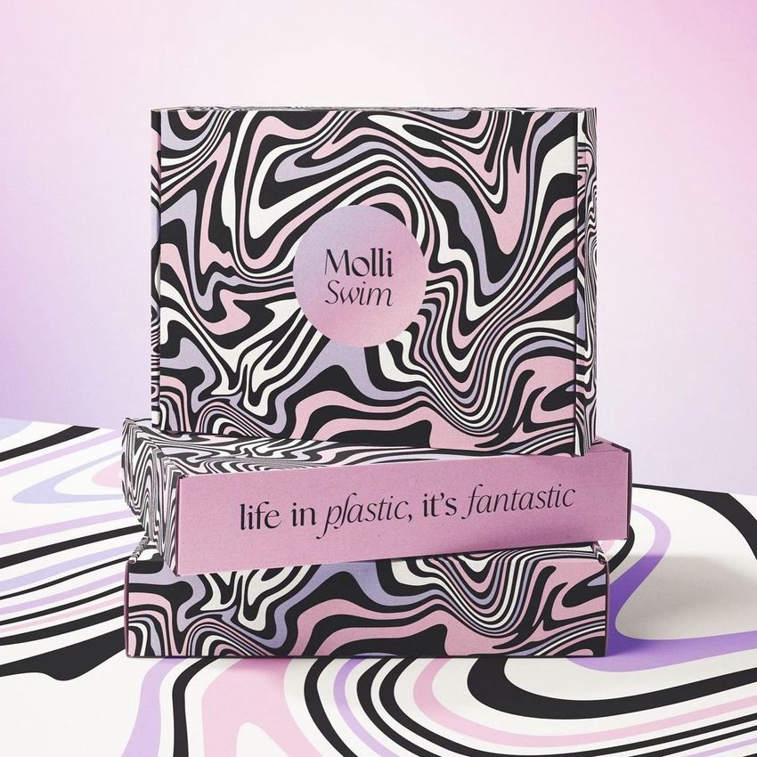 Mailing box mockup featuring bold black, white, and pink wavy patterns, with circular and rectangular text elements on the front.