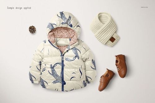 Kids winter set mockup featuring a cream puffer jacket with blue fish pattern, scarf, and brown shoes on white background.