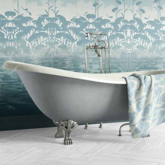 Victorian style bathroom mockup showing a freestanding clawfoot bathtub with a patterned towel draped over the side and a blue botanical wallpaper background.