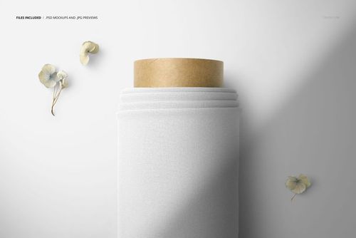 Top view close-up of a fabric roll mockup with plain white textile wrapped around a cardboard core on a light surface.