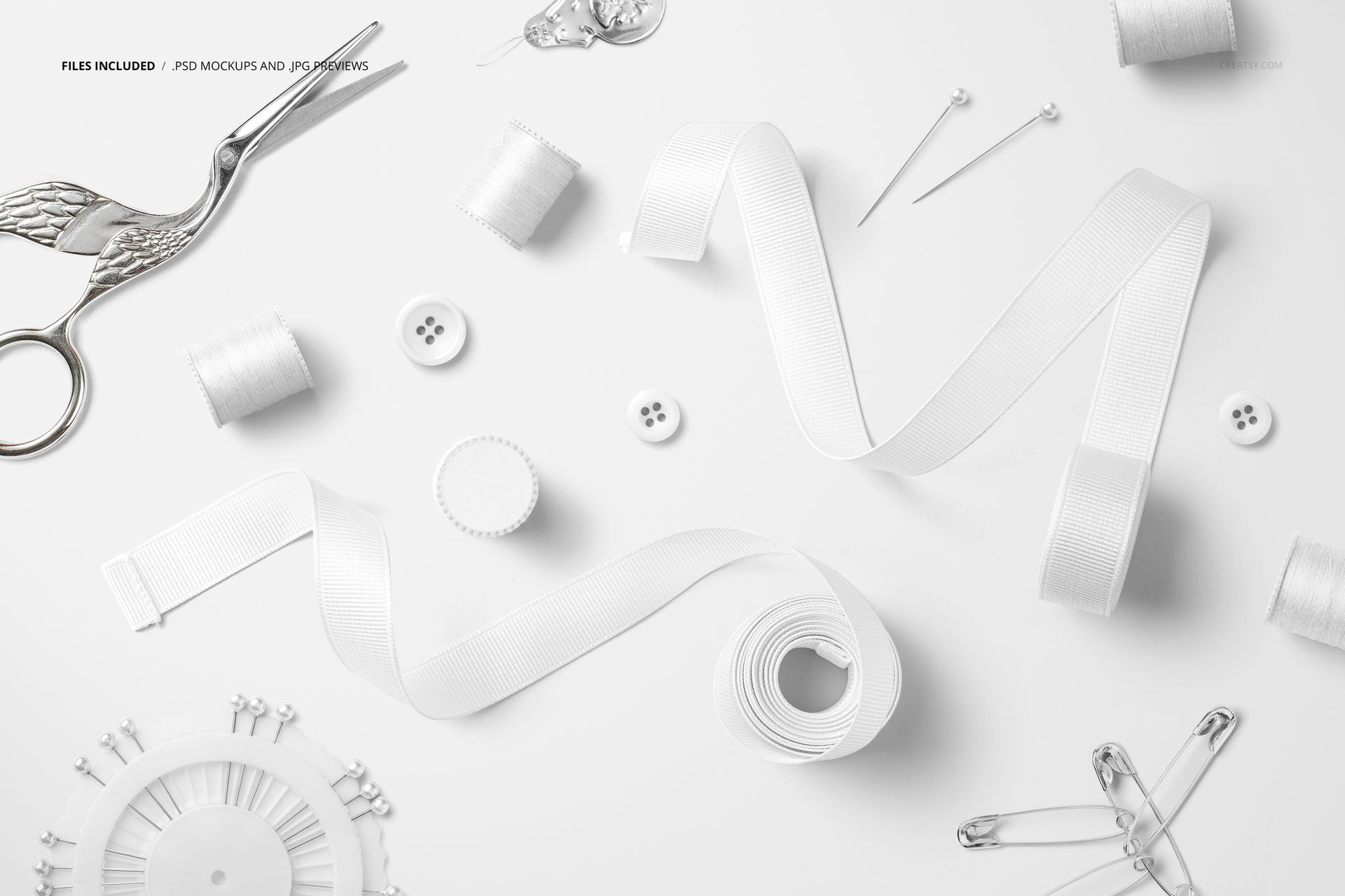 White grosgrain ribbons displayed with sewing tools such as safety pins, spools, and buttons in a PSD mockup scene.