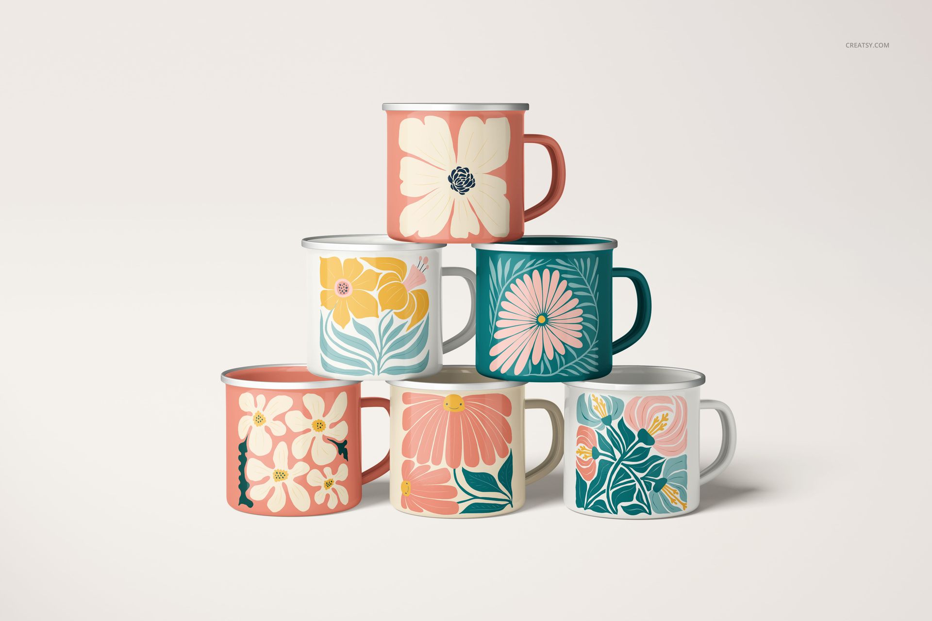 PSD mockup showing enamel mugs with silver rims, each with unique botanical artwork, set against a neutral backdrop.