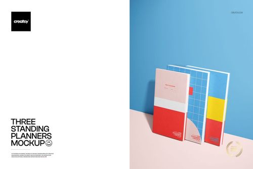 PSD mockup featuring three upright planners with red, blue, and yellow covers against a pastel background.