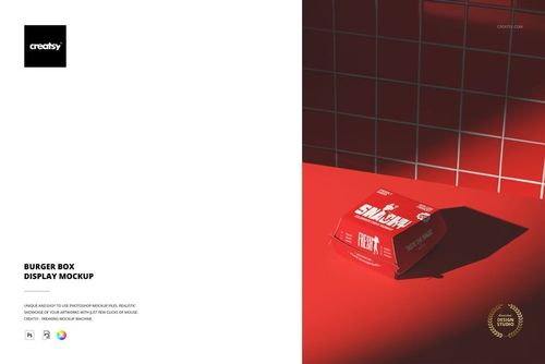 Burger box mockup featuring a closed rectangular box with bold graphics on a red surface and red tiled wall background.