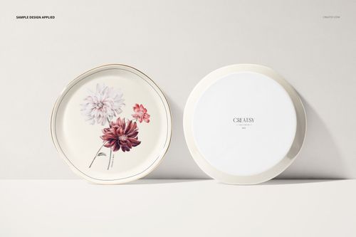 Two round plates on a light surface, one with floral artwork and one plain, shown in a front-facing mockup scene.