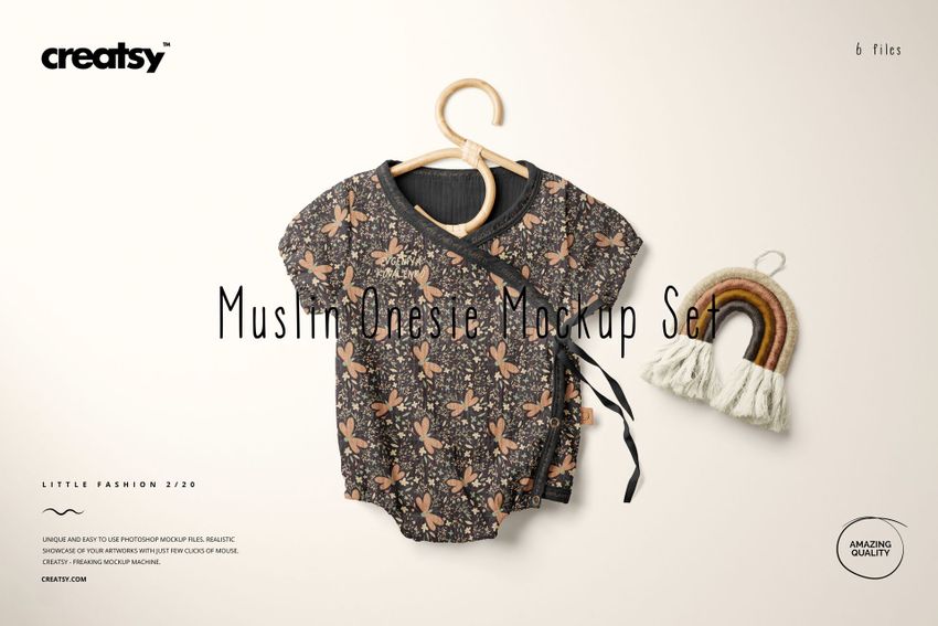 Muslin onesie mockup featuring a dark floral design, displayed on a hanger beside a woven rainbow ornament.
