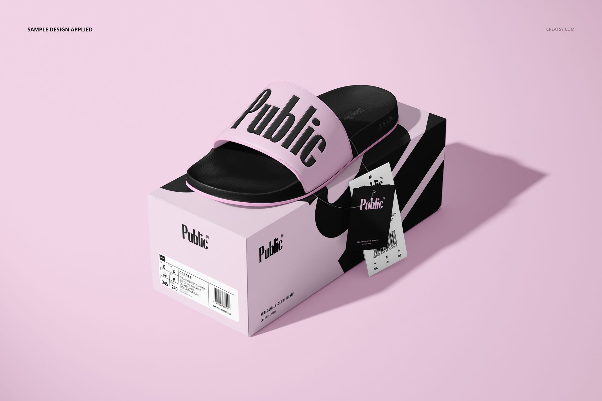 Black and pink slide sandal mockup shown on a custom box with product tag, set on a pastel pink surface.