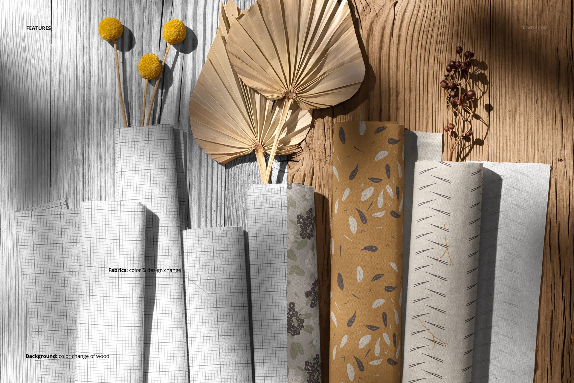 Boho style cotton fabrics mockup showing rolled textiles in assorted patterns and shades, displayed on a wooden tabletop.