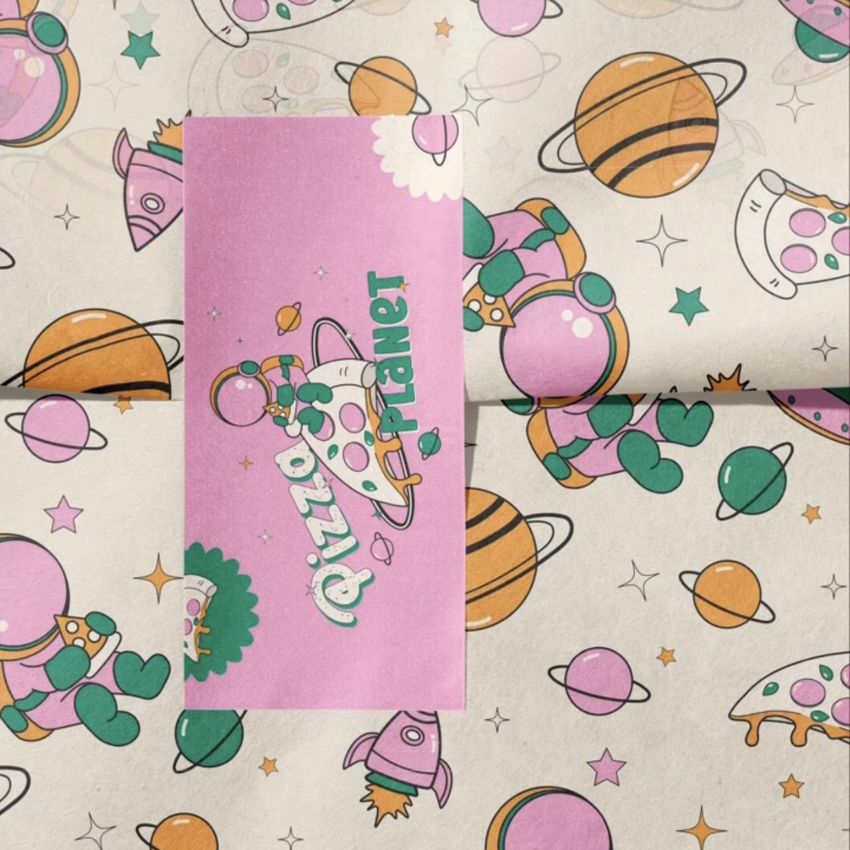 Sticker mockup featuring a pink rectangular sticker with playful cartoon astronauts and planets on a matching illustrated background.