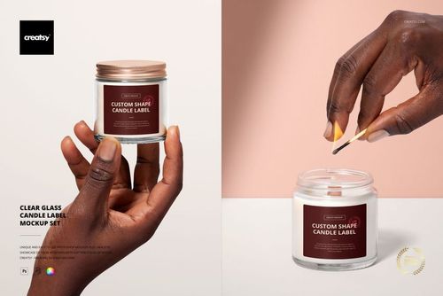 PSD mockup of a clear glass candle jar with a brown lid and custom label, displayed in two different hand-held scenes.
