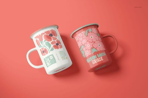 PSD mockup of enamel mugs with botanical prints, one in white and one in coral, arranged side by side.