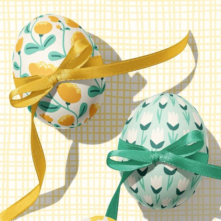 Easter egg crafts mockup featuring two decorated eggs with floral patterns and ribbon bows on a yellow grid background.