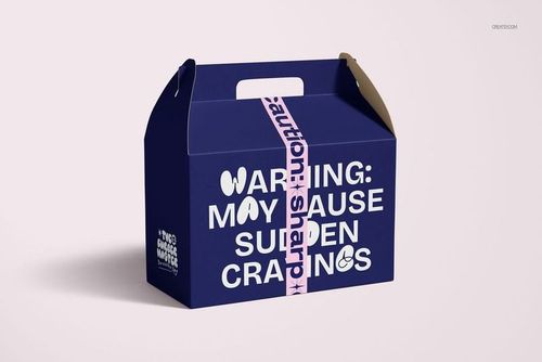 PSD mockup showing a blue box with white text, sealed with pink duct tape printed with black caution and sharp warning details.