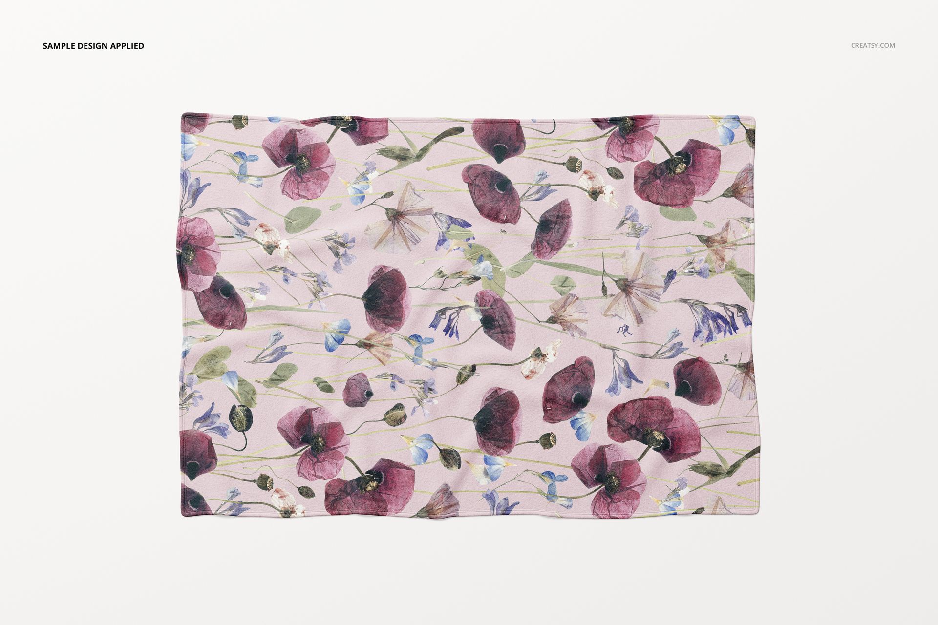 Mockup of a fleece throw blanket featuring watercolor-style flowers in purple and blue, shown from a top view.