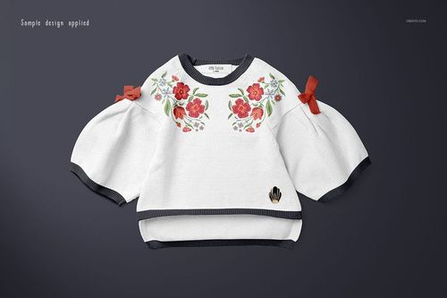 Front view of a baby sweater mockup with white fabric, floral red and green design, and dark trim on sleeves and hem.