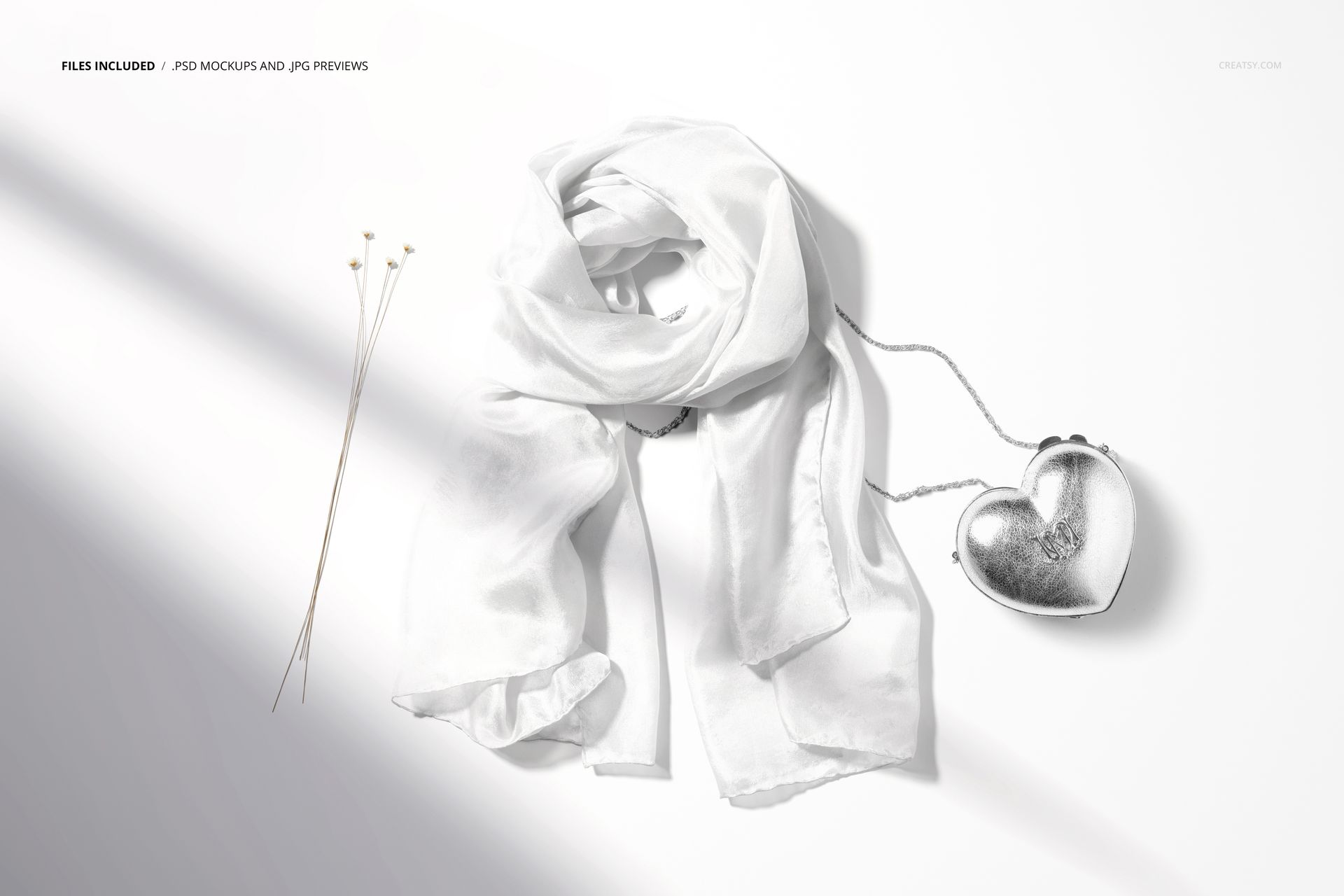 Fashion accessories mockup showing a sheer white silk scarf and metallic heart bag arranged on a clean surface.