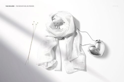 Fashion accessories mockup showing a sheer white silk scarf and metallic heart bag arranged on a clean surface.