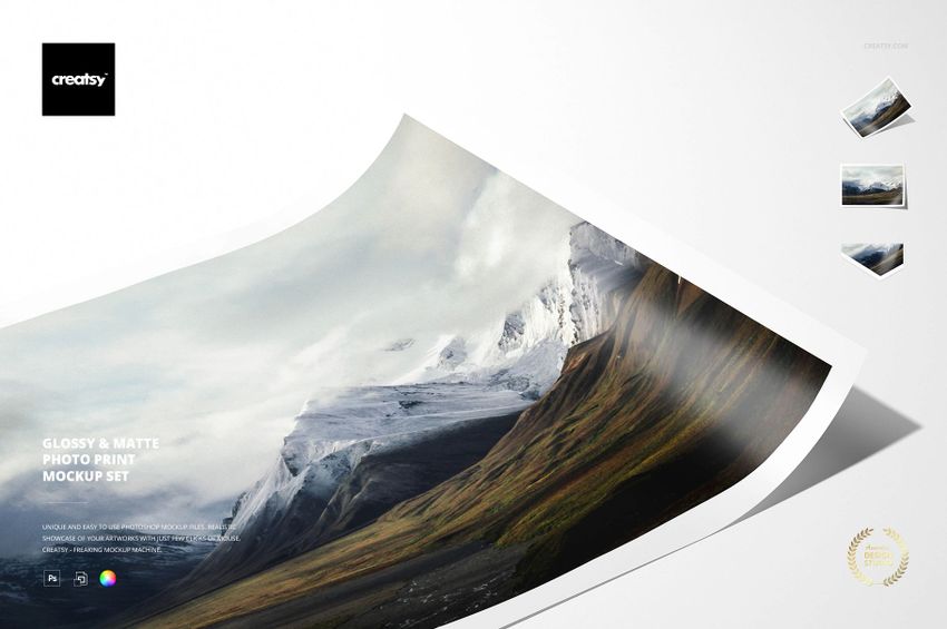 Matte photo print mockup displaying a scenic mountain view, angled on a light background with minimal props.