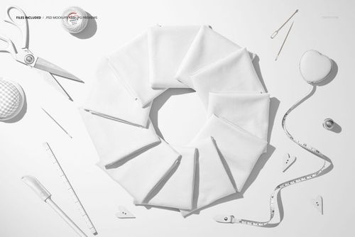 PSD mockup showing multiple folded white fabric segments in a circle, accompanied by various sewing accessories.