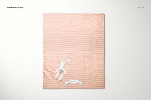 Baby patchwork quilt mockup shown flat on a light background, pink fabric with tiny dots and a stuffed bunny accent.