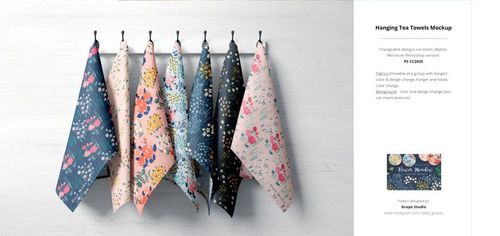 Front view of patterned fabric towels hanging on hooks, showcasing different floral designs in a PSD mockup scene.