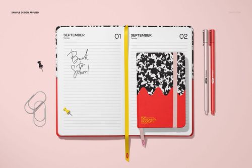 PSD mockup showing two open leather calendars with handwritten notes, pens, and paper clips arranged on a pastel surface.