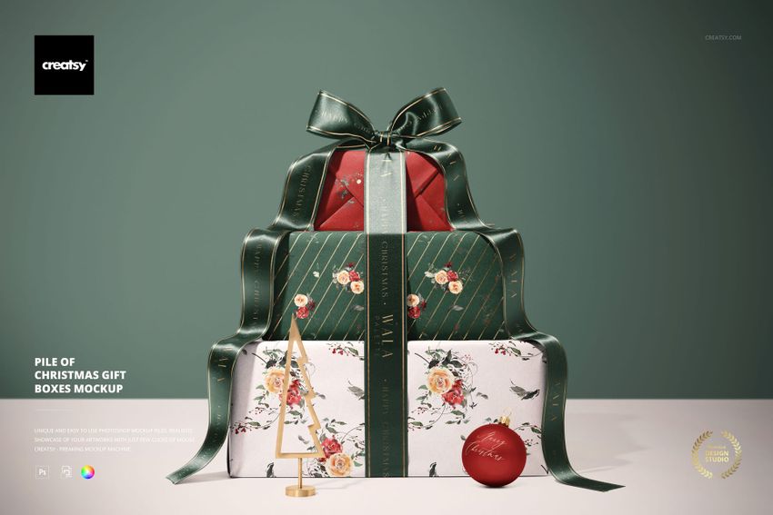 Christmas gift boxes mockup featuring floral and striped patterns, wide ribbon, small wooden tree, and ornament.