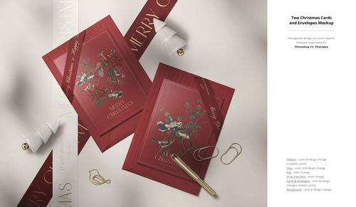 Christmas card PSD mockup featuring two red cards with botanical designs, envelopes, ribbon, and festive props arranged flat.