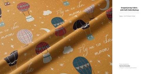 Jersey fabric mockup with colorful hot air balloon pattern, white clouds, crescent moons, and handwritten text, angled view.
