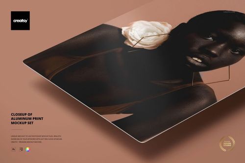 Angled close-up of an aluminum print mockup displaying a woman's portrait, with soft shadows and a neutral backdrop.