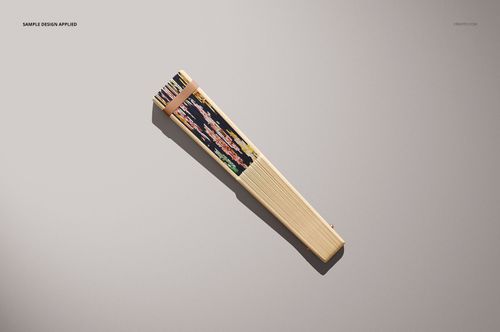 Fabric hand fan mockup featuring a closed wooden fan with colorful floral fabric, displayed from above on a neutral background.