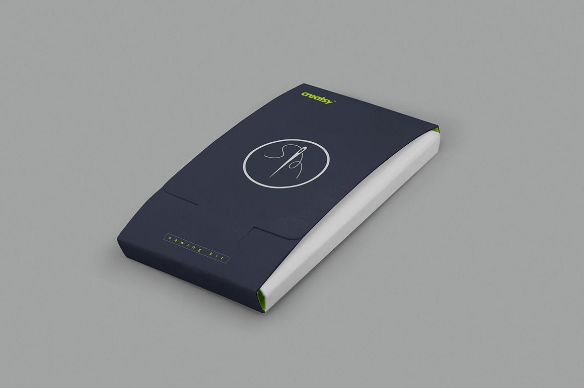 Mockup of a rectangular sewing kit box in dark blue with white accents, presented at a slight diagonal angle.
