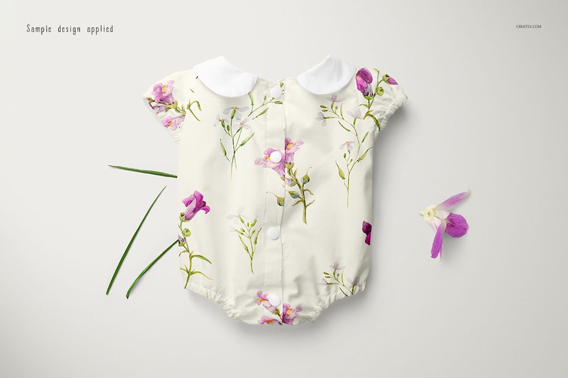 PSD mockup of a baby romper displayed flat, adorned with pink and purple flower designs and green stems.