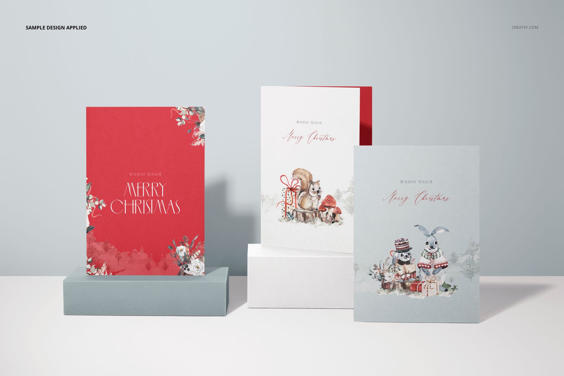 Holiday-themed 5x7 cards mockup with colorful illustrations, arranged vertically on minimalist white stands.