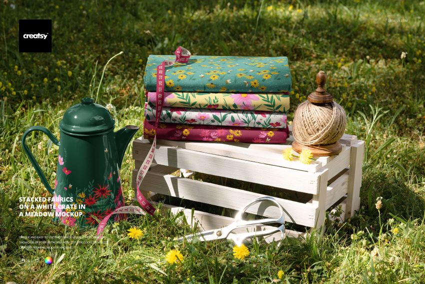 Stacked Fabrics on a White Crate in a Meadow Mockup - mockup screenshot 1
