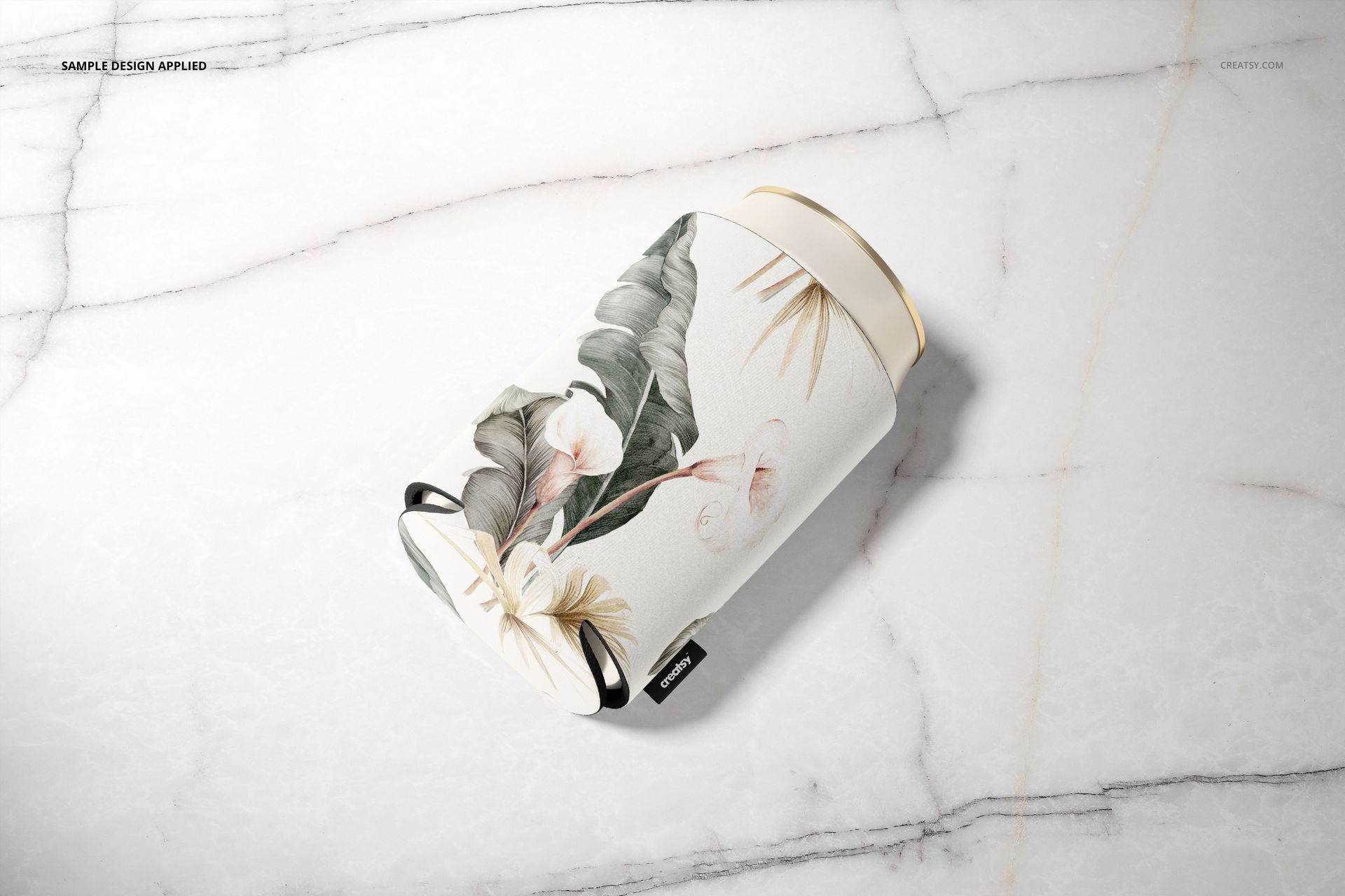 PSD mockup of a neoprene can cooler featuring a botanical design, displayed on a light marble background.