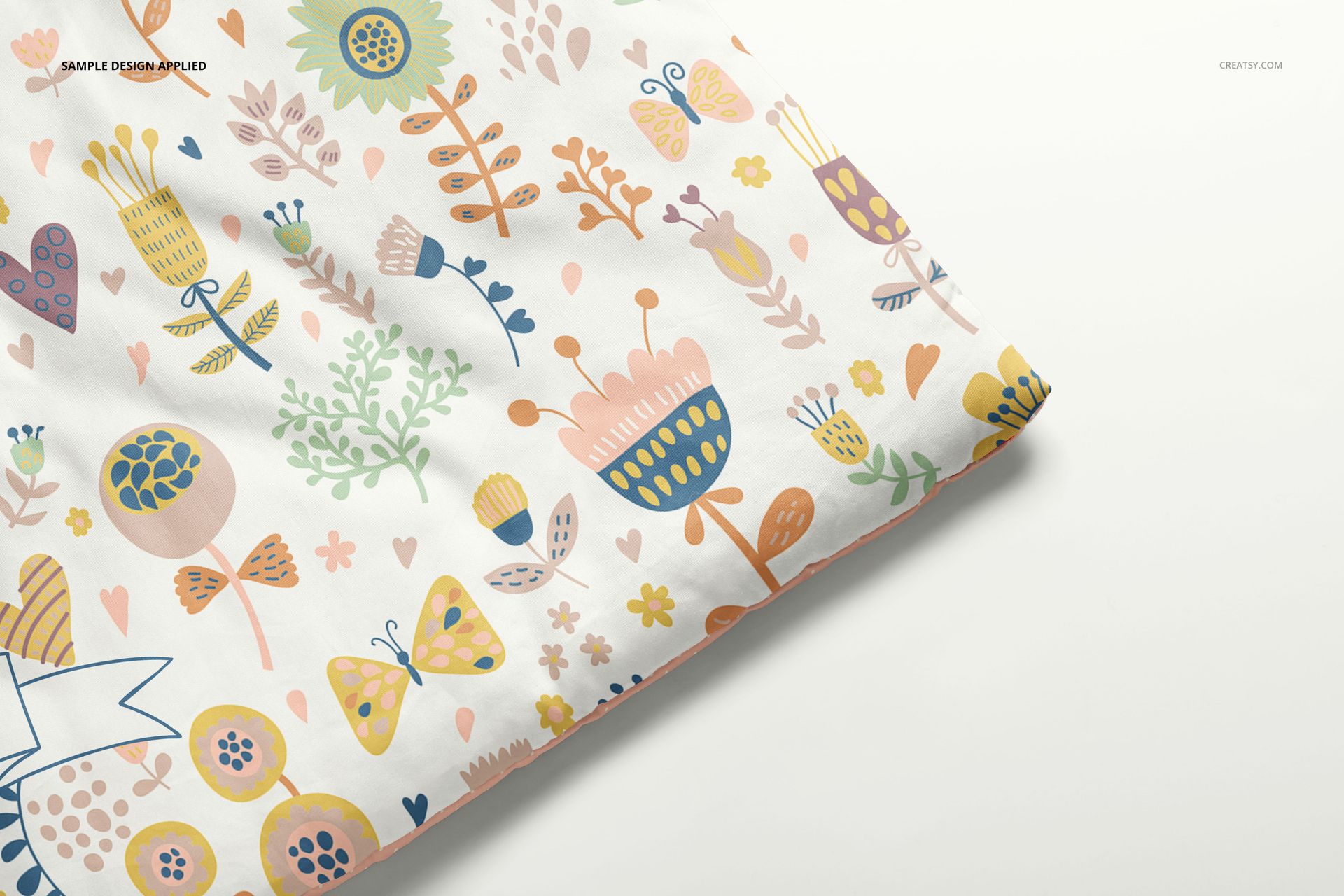 PSD mockup of a baby duvet cover featuring pastel flowers and butterflies, displayed from a side angle.